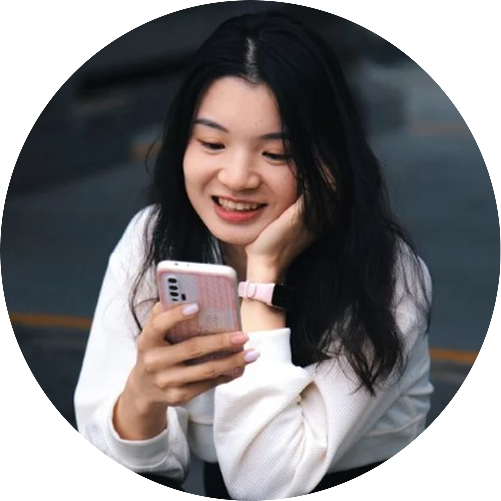 A person happily looking at a smartphone
