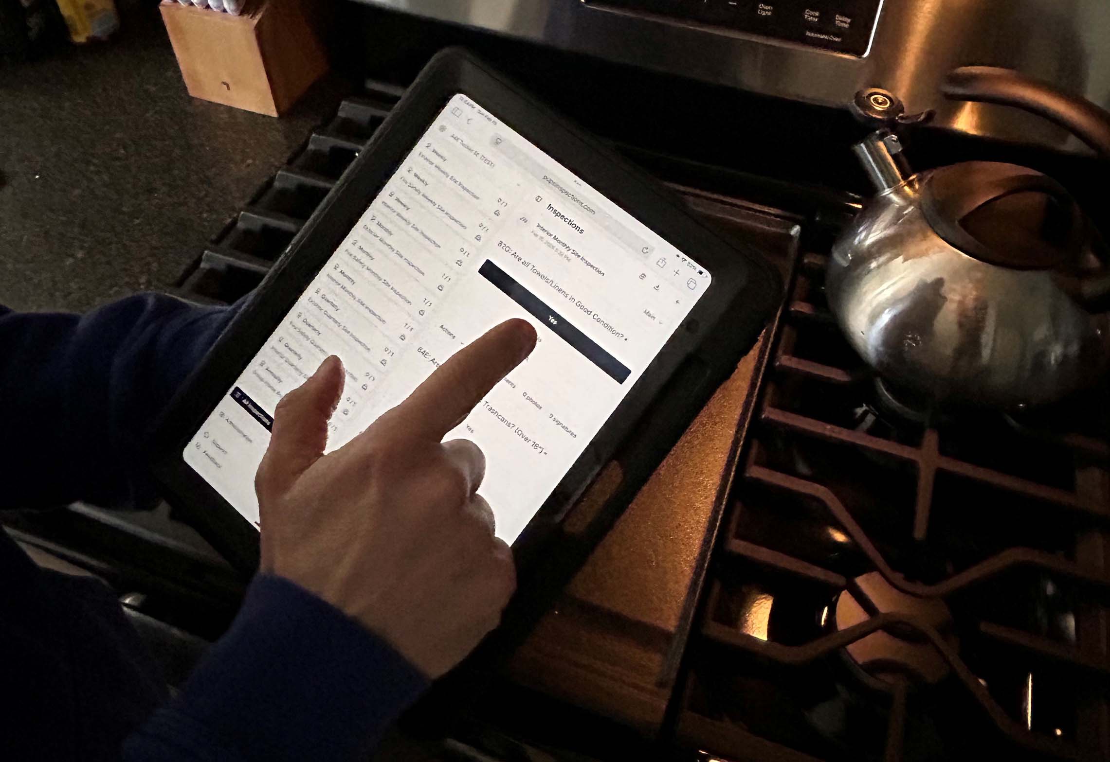 A person using a tablet while conducting inspection