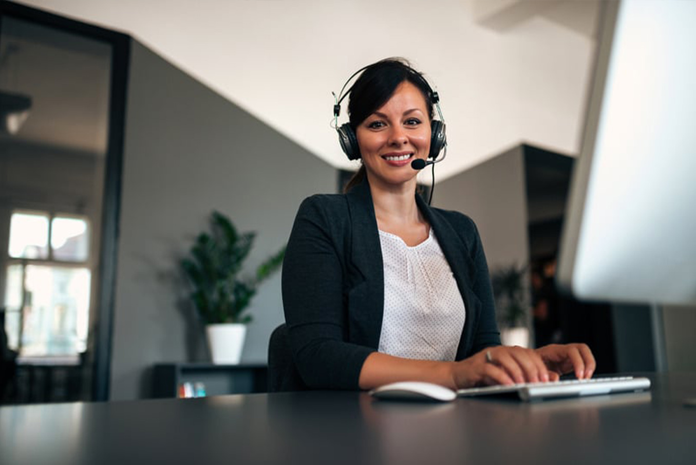 Woman wearing a headset while using a computer